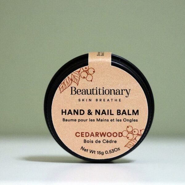 Minimalist shot of Beautitionary’s Cedarwood Hand and Nail Balm tin, crafted with shea butter, black currant seed oil, and oat & kale protein to keep hands smooth, healthy, and cuticles strong.