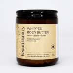 Golden Turmeric Whipped Body Butter displayed in a glass jar, featuring a soft whipped texture and nourishing blend of turmeric, rose, and plant butters for smooth, hydrated skin.